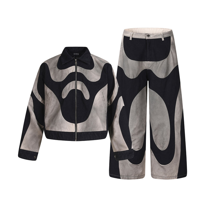 Black and grey two-piece outfit with cropped zip jacket and wide-leg pants in matching abstract patchwork