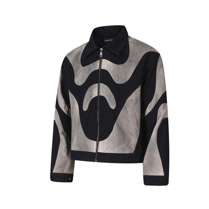 Front view of a cropped black and grey jacket with zip closure, pointed collar, and curved abstract panels