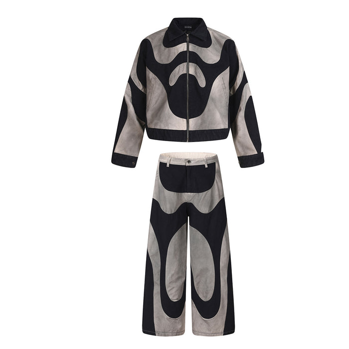 Front view of the matching black and grey cropped jacket and wide-leg abstract patchwork pants