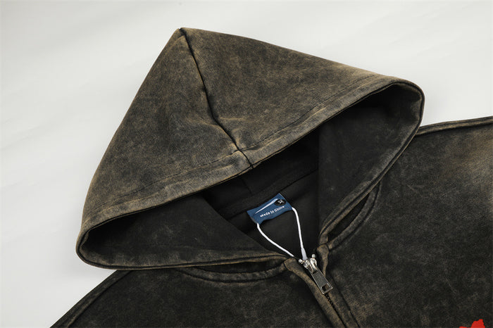 Close-up of the acid-wash hoodie hood, zipper, neck seam, and attached garment label