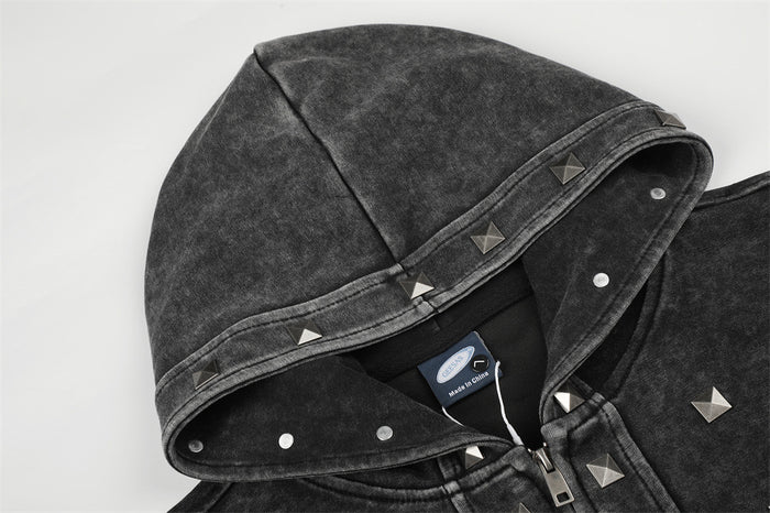 Close-up of the acid-washed black hood showing snap closures, studded trim, and the front zipper
