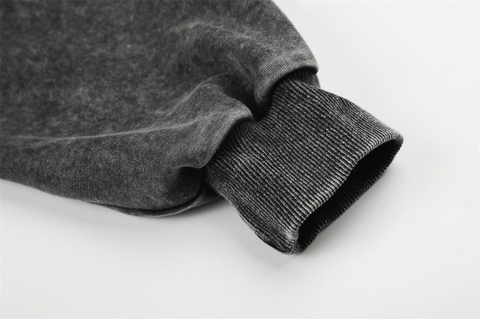 Close-up of the hoodie sleeve ending in a textured ribbed black cuff