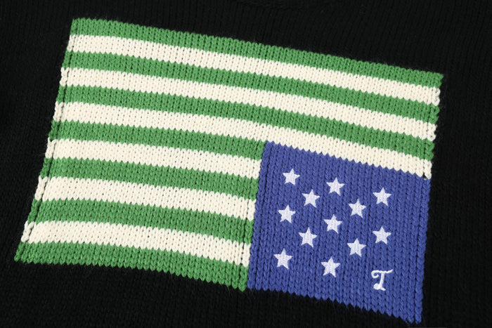 Close-up of green and cream knitted stripes beside a blue panel decorated with white stars