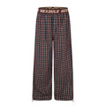 Front view of burgundy plaid wide-leg pants with elastic waistband and drawcord hems