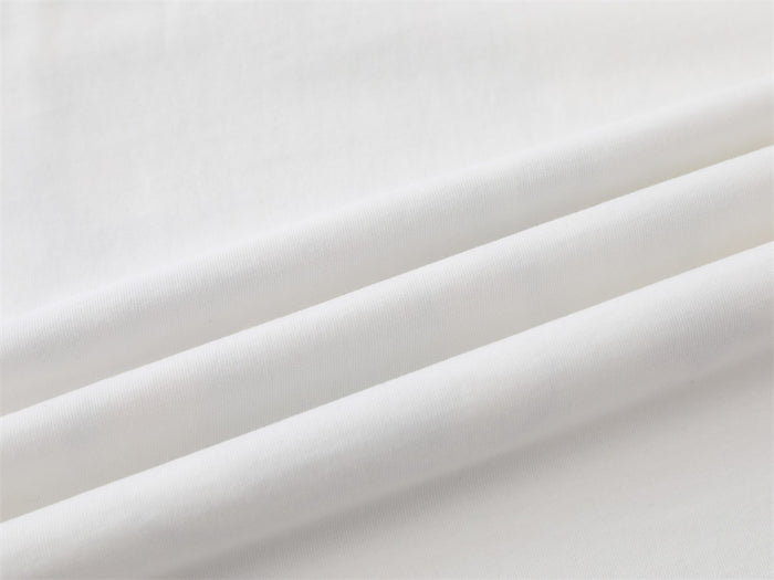 Close-up of smooth white T-shirt fabric with folded seam detail
