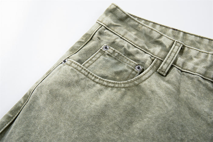 Close-up of the front pocket and waistband on army green cargo pants
