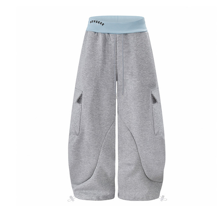 Front view of gray wide-leg cargo sweatpants with a light blue ribbed waistband, drawstring, and curved seam pockets