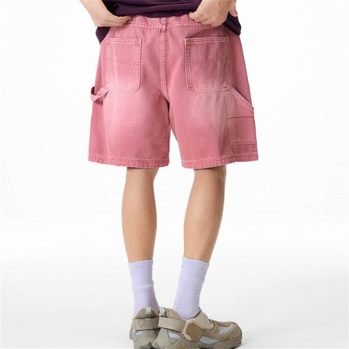 Pink carpenter denim shorts shown from the back with two rear pockets and side cargo pockets