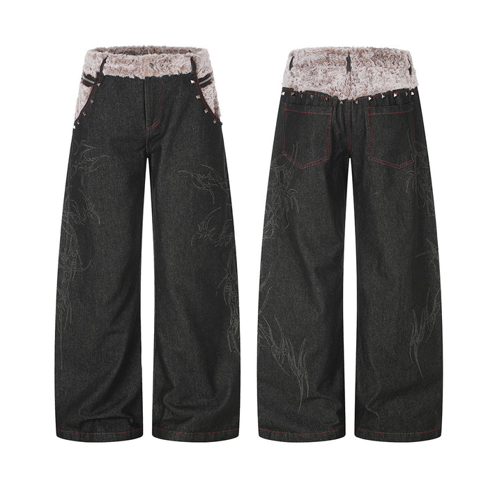 Black wide-leg baggy jeans with fold-over sherpa waistband, pyramid studs, and tonal tribal embroidery, front and back view