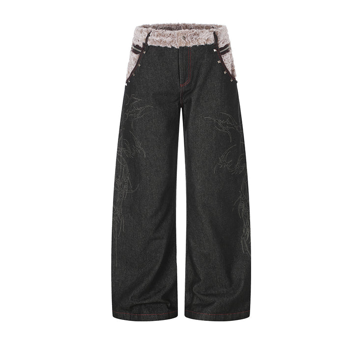Front view of black wide-leg jeans with a plush beige fold-over waistband, red stitching, and subtle leg graphics