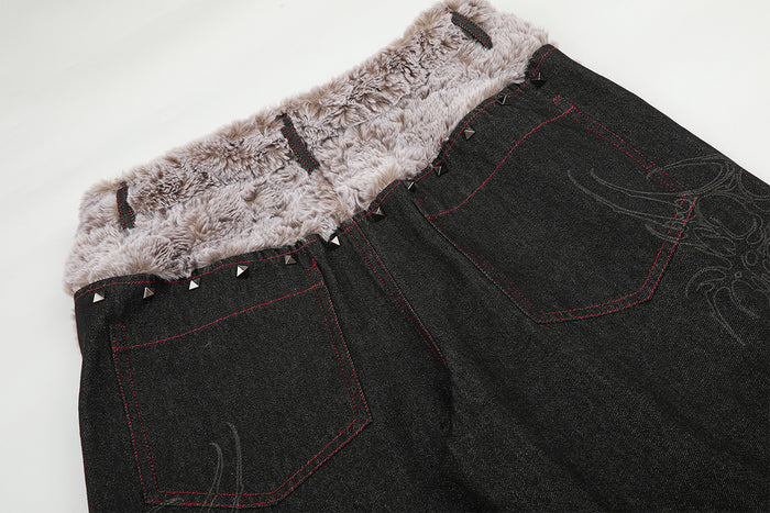 Close-up of the jeans back showing the plush fold-over waistband and two red-stitched patch pockets