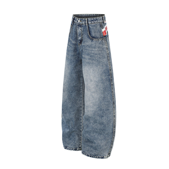 Side view of light blue wide-leg jeans showing the curved leg silhouette, front pocket and waistband detail