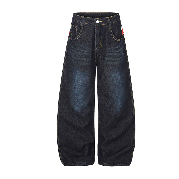 Front view of dark wide-leg jeans with yellow stitching, curved front pockets and faded blue thigh highlights