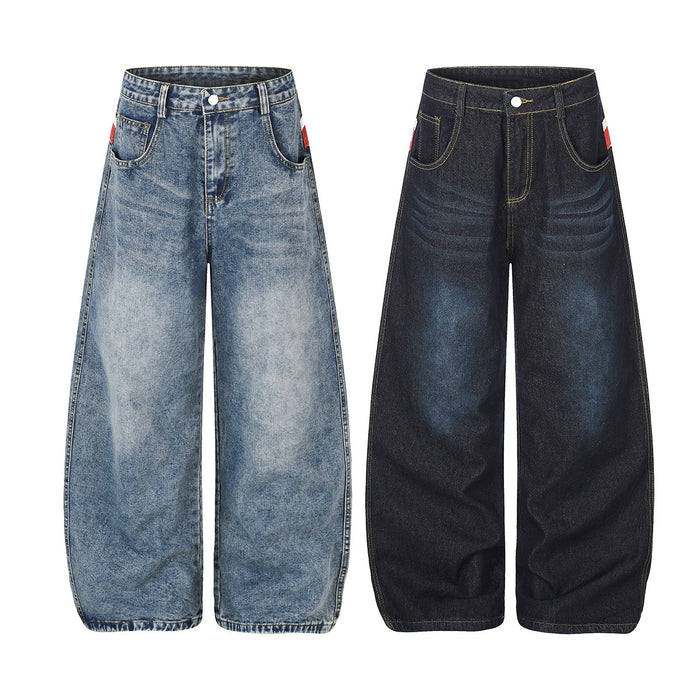 Front view of light blue and dark wide-leg jeans with faded thigh highlights, curved pockets and yellow stitching
