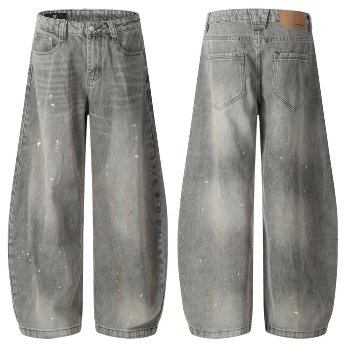 Grey acid-washed wide-leg jeans shown from the front and back with white paint splatters