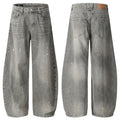 Grey acid-washed wide-leg jeans shown from the front and back with white paint splatters