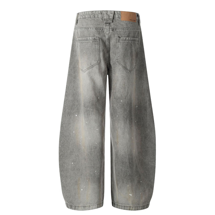 Back view of grey acid-washed wide-leg jeans with two stitched rear pockets and white paint flecks
