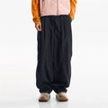Unisex oversized wide-leg parachute pants in midnight black with elastic waist and cinched ankle cuffs