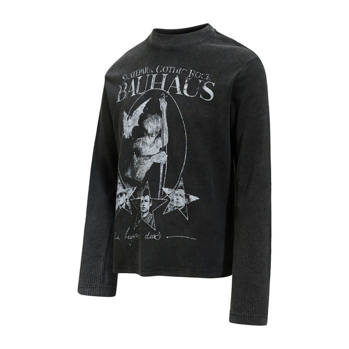 Angled front view of a black waffle knit long sleeve shirt with distressed white Bauhaus graphic