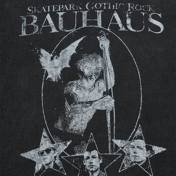 Close-up of the shirt graphic showing a monochrome central figure, crescent outline, and star portraits
