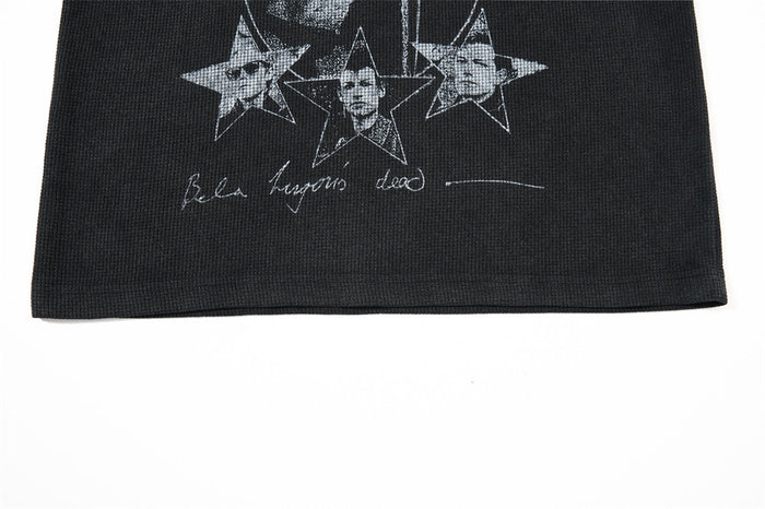 Lower front close-up showing three star portraits, cursive white lettering, and the black shirt hem