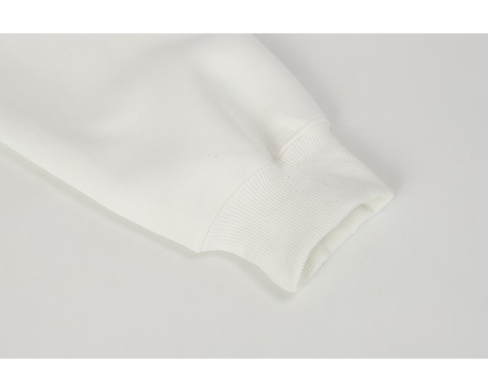 Close-up of white ribbed sleeve cuff on the hoodie
