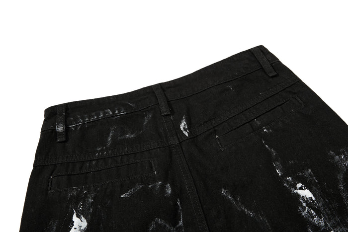 Back waistband close-up of black washed denim with belt loops and top pockets