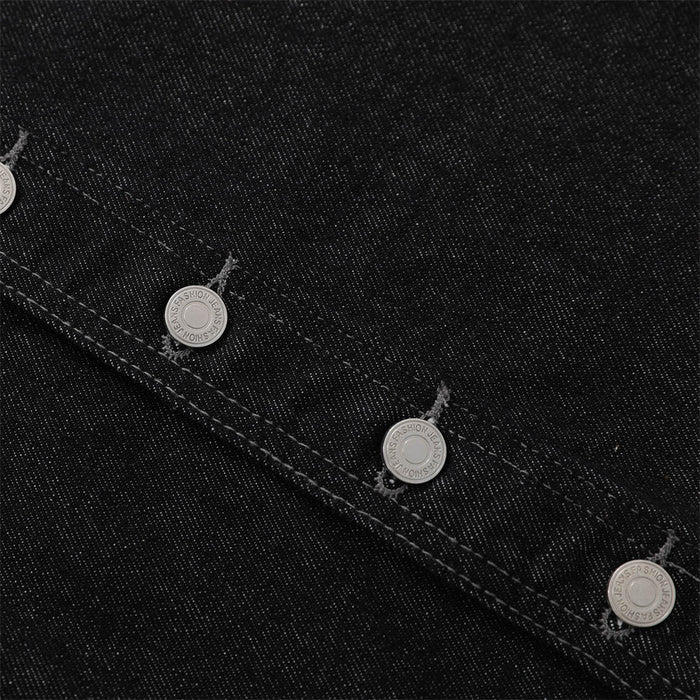 Extreme close-up of black denim fabric and diagonal button placket stitching