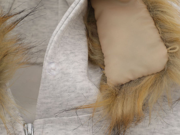 Close-up of hood lining, faux fur trim, and snap detail on light gray hoodie