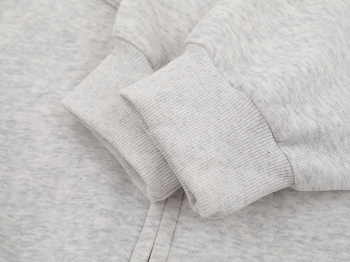 Close-up of light gray hoodie ribbed sleeve cuff and hem stitching