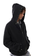 Side view of a black zip-up hoodie with raised hood, metal spikes, and a washed finish