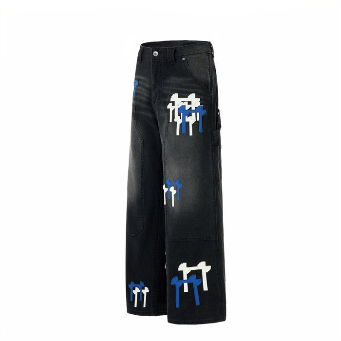 Side view of black cargo jeans showing the wide leg, side cargo pocket, and layered cross patches
