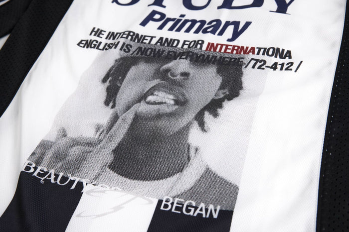 Close-up of the jersey front showing a monochrome portrait graphic with overlaid black and red text
