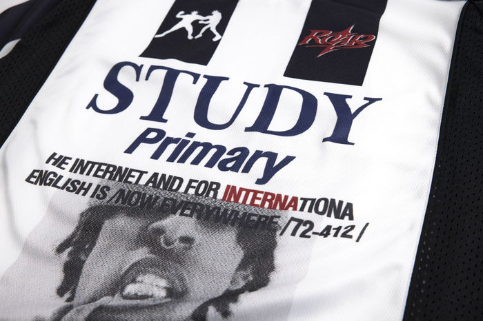 Close-up of the striped jersey chest with large STUDY lettering, smaller text, and two contrasting logos