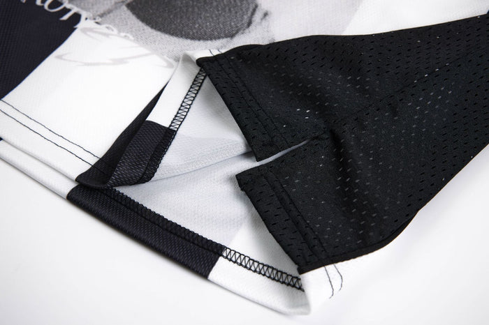 Close-up of the jersey hem and black perforated sleeve fabric showing stitched seams and edge finishing
