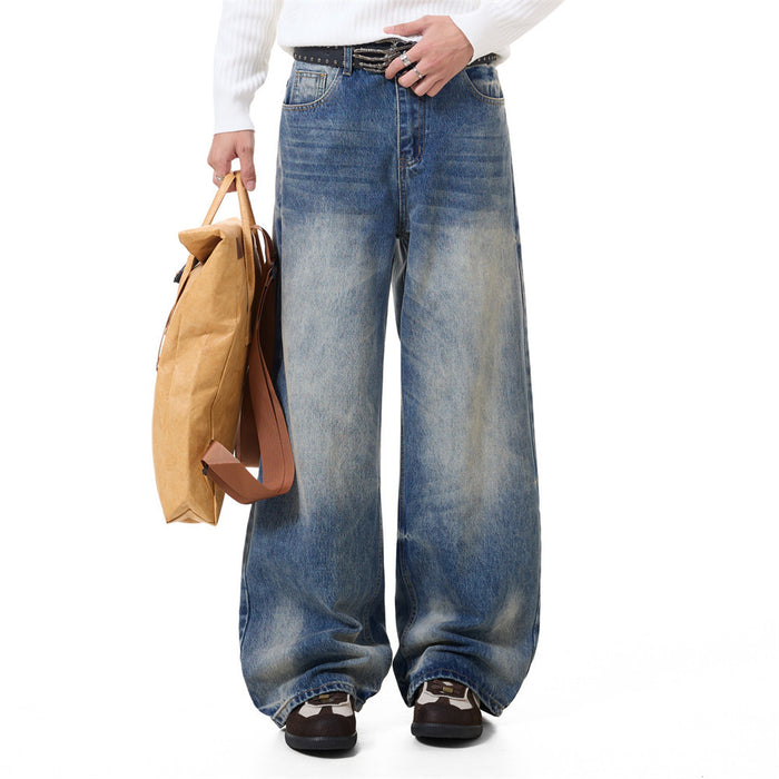 Front view of blue wide-leg jeans with vintage fading, worn by a model with a brown paper bag