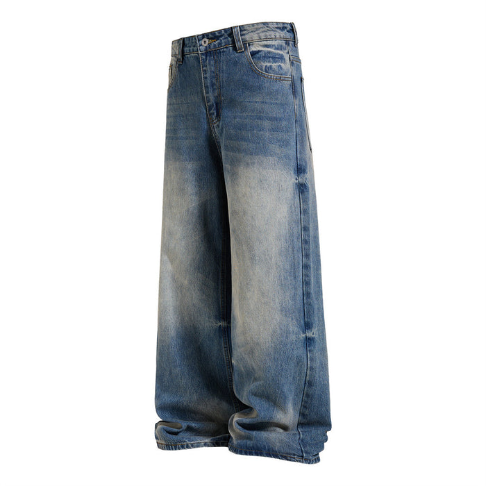 Angled side view of blue baggy jeans showing the wide straight-leg silhouette and faded denim wash