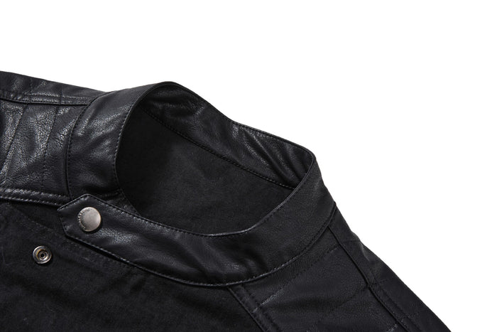 Close-up of the black stand collar with a snap fastening, PU leather trim and visible denim stitching