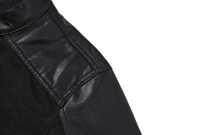 Close-up of the jacket shoulder showing a glossy black PU leather panel with stitched detailing