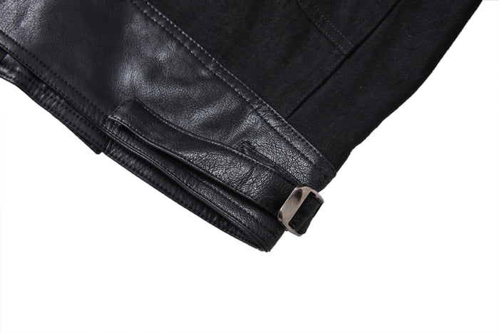 Close-up of a black PU leather waist adjustment tab with a metal buckle and stitched edge