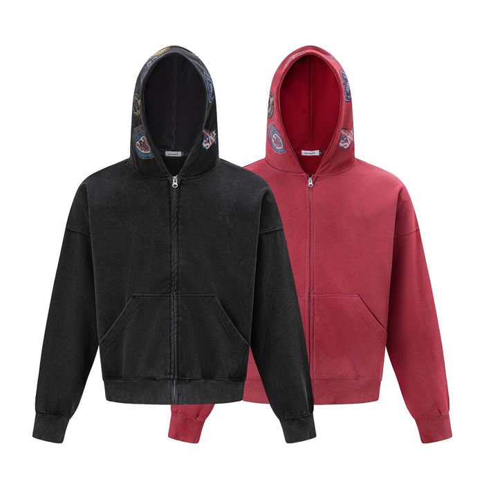 Black and red acid-wash zip-up hoodies shown from the front with embroidered hood patches and kangaroo pockets