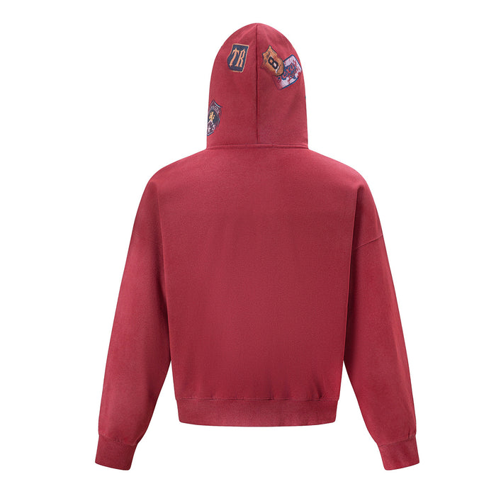 Back view of the red acid-wash zip-up hoodie with embroidered patches visible on the hood