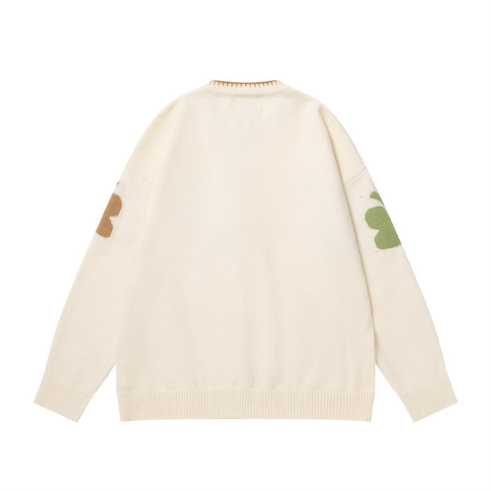 Back view of cream knit zip-up cardigan with partial brown and green butterfly motifs on the sleeves