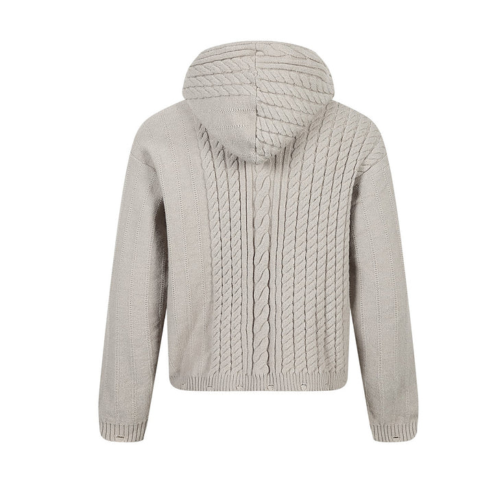 Back view of a beige hooded zip-up sweater showing vertical cable-knit panels and ribbed cuffs