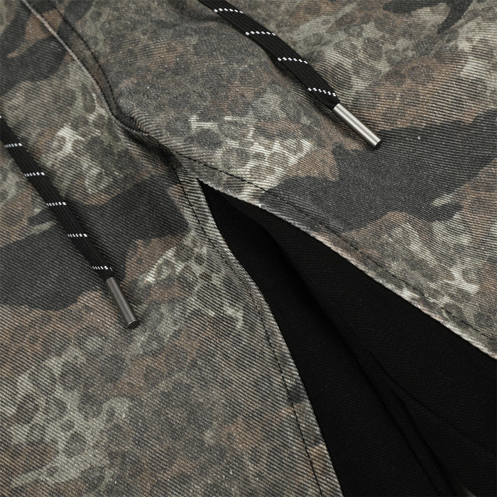 Detail of camouflage pants drawstrings, metal tips and black contrast inner panel