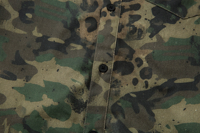 Close-up of button placket on camo leopard utility overshirt