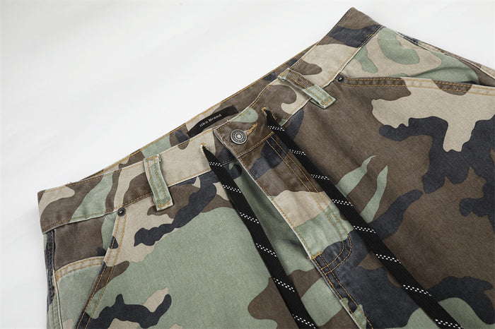 Close-up of the waistband on camo cargo pants with drawstring and belt loops