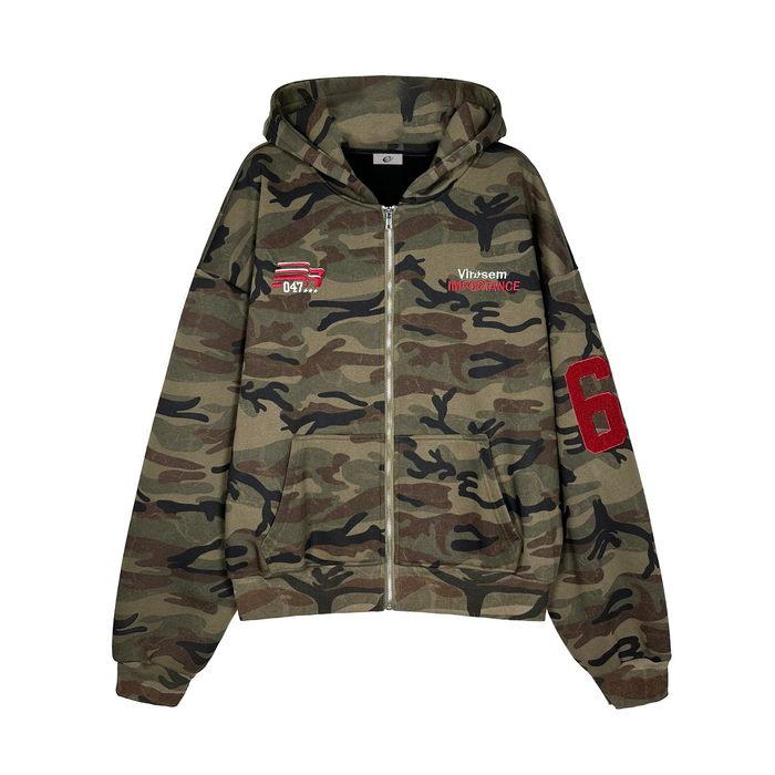 Front view of camo zip hoodie with hood up, chest embroidery, and pouch pockets