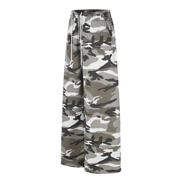 Side view of wide-leg camouflage sweatpants with elastic waistband and loose drape