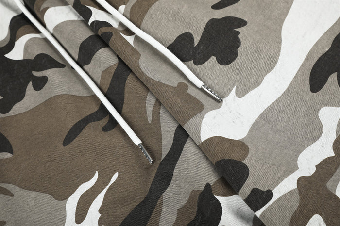 Close-up of white drawstrings with metal tips on camouflage sweatpants